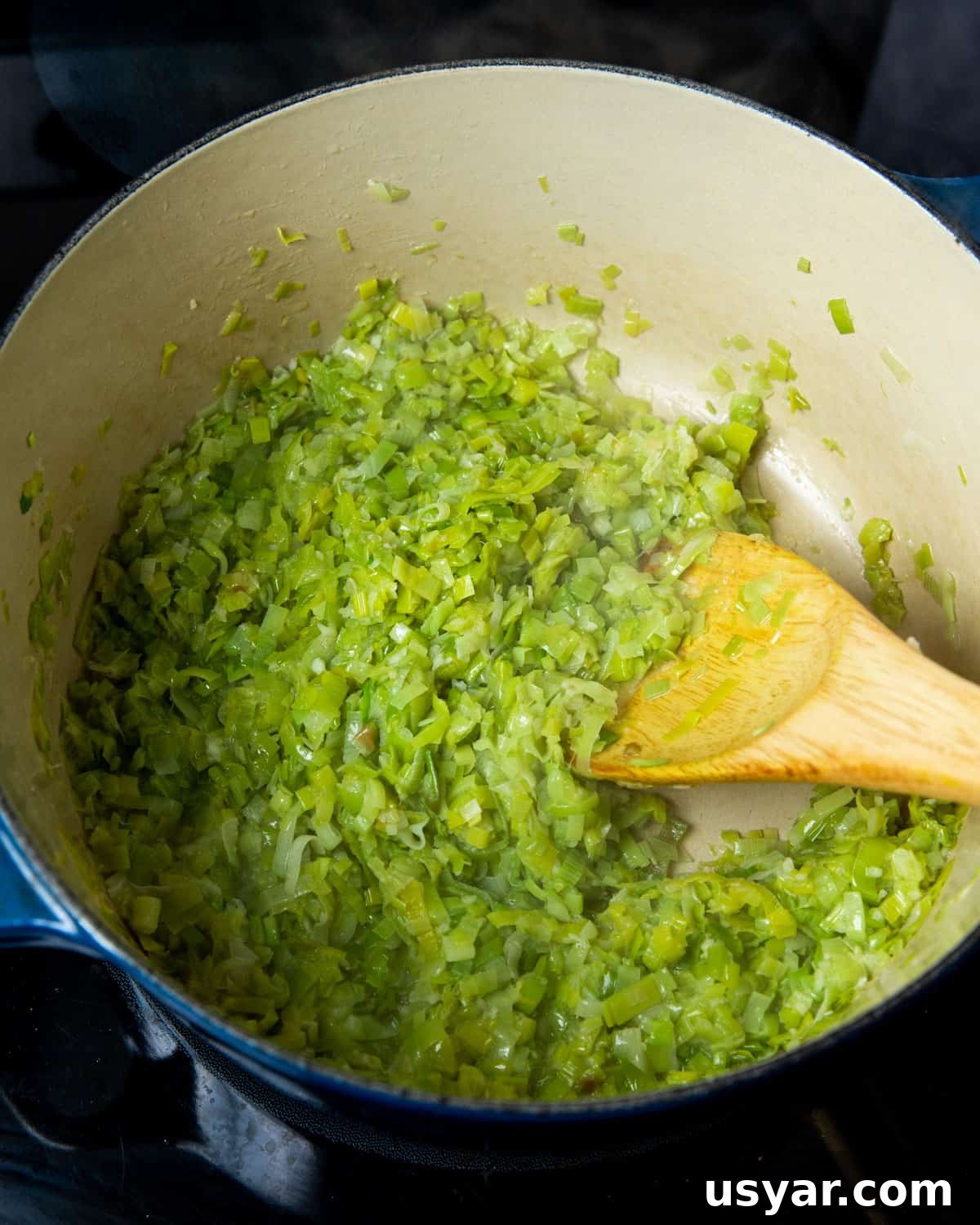 Creamy Vegan Leek and Potato Soup Vichyssoise 11 Photo of leek and garlic cooked down in a pan.