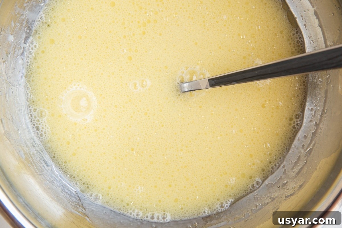 Wet ingredients for waffles in a mixing bowl