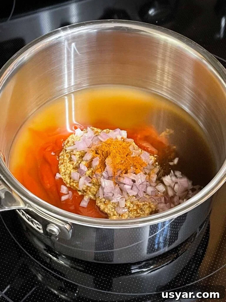 Carolina-Style Grilled Chicken Burger Recipe 6 Ingredients in a sauce pan to make Carolina barbecue sauce.