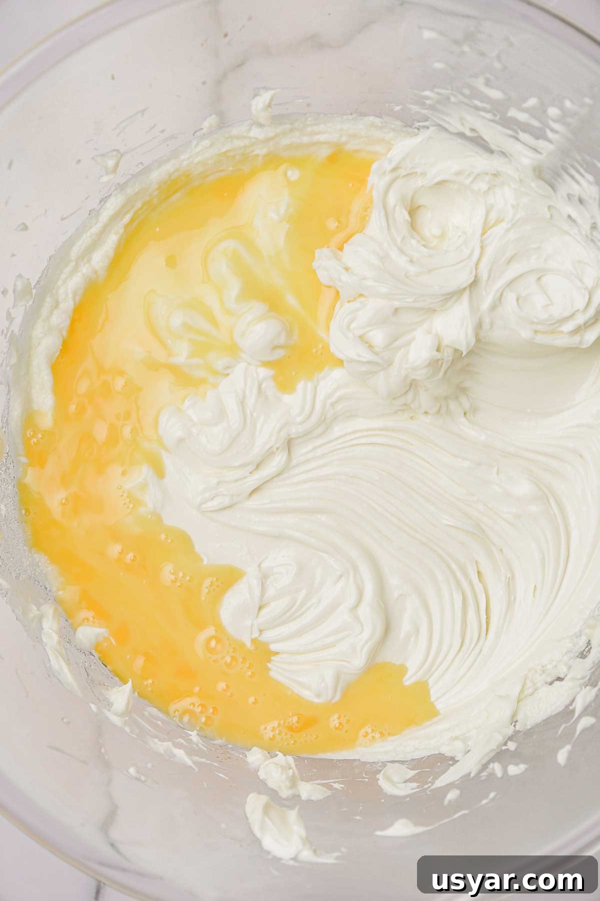 eggs mixed in a bowl for oreo cheesecake filling