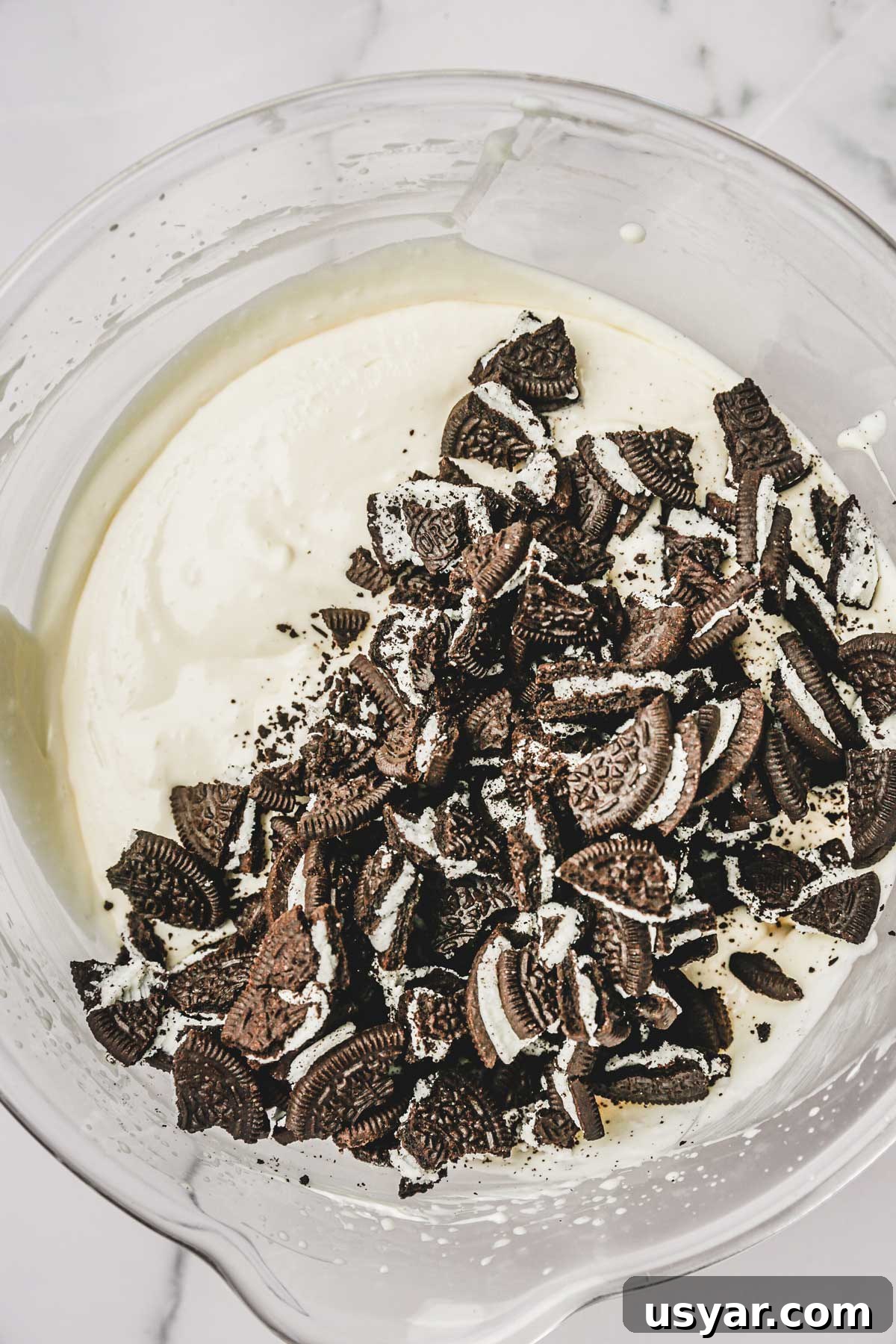 oreo cheesecake batter with crushed oreo cookies in bowl