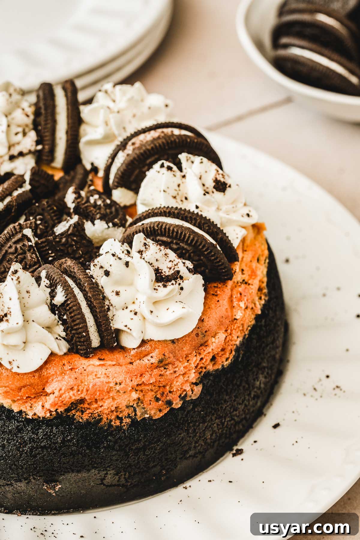 whole baked oreo cheesecake on a serving plate