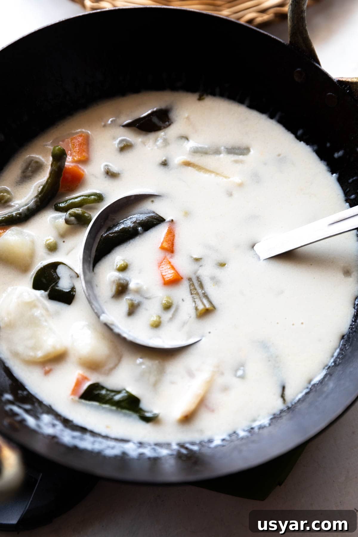 Kerala Vegetable Stew with Coconut Milk 4 kerala veg stew in a black kadai with ladle