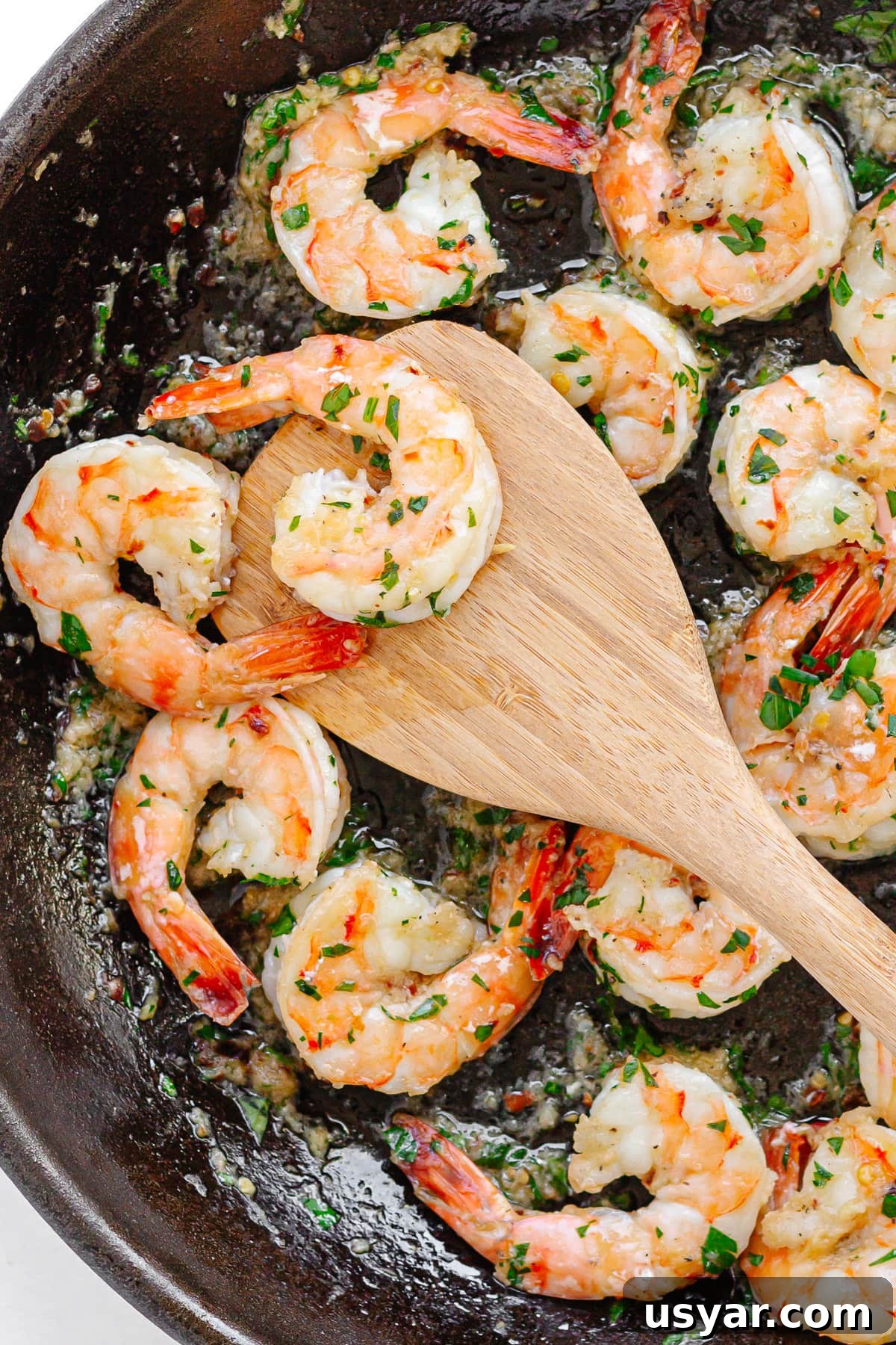 Pan fried shrimp in a cast iron skillet.
