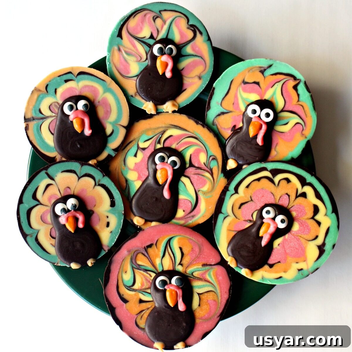 DIY Chocolate Turkey Recipe for Thanksgiving 3 Colorful Chocolate Bark Turkey discs on a serving platter.