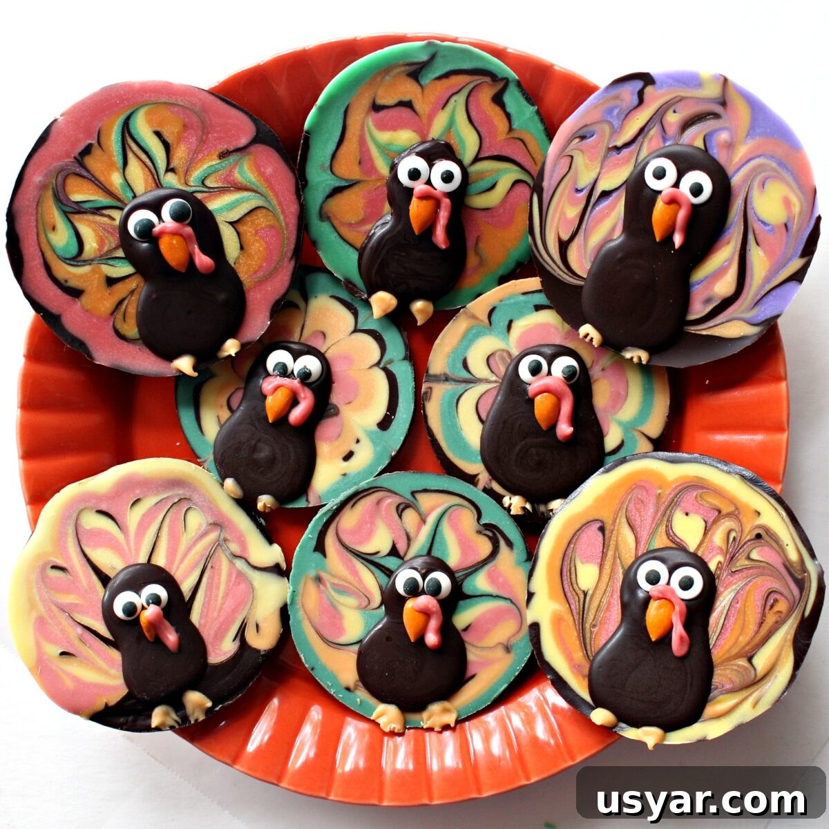 DIY Chocolate Turkey Recipe for Thanksgiving 8 Disc shaped Thanksgiving Chocolate Turkeys made with colored and dark chocolate on a serving plate.