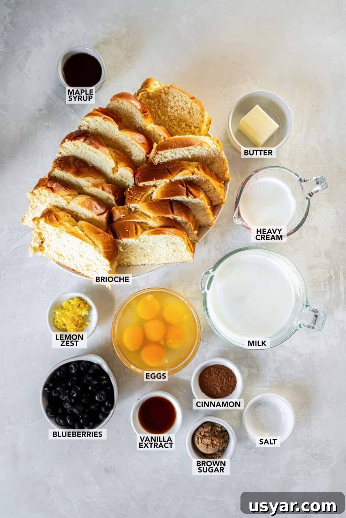 Ingredients for blueberry brioche French toast bake including brioche, blueberries, eggs, milk, and cinnamon