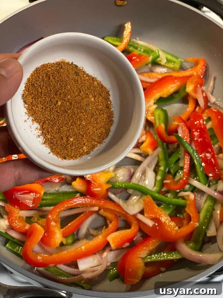 process of seasonings being poured into pan of veggies