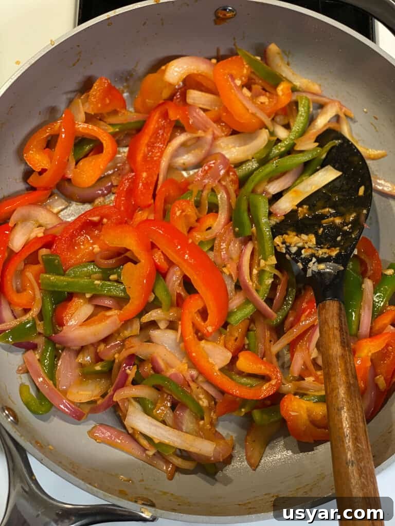 process of stirring ingredients for Vegan Fajita Tacos in pan