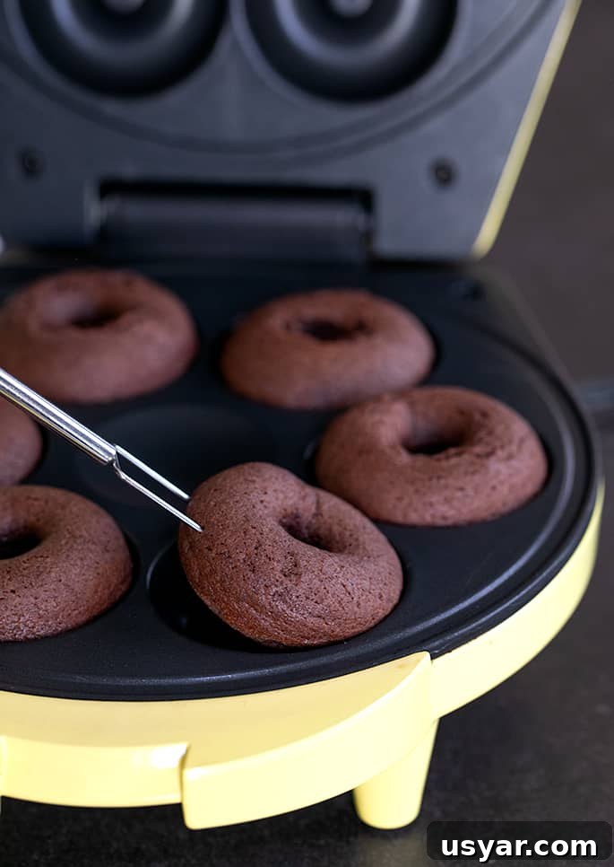 Gluten-Free Chocolate Donuts Recipe (Moist and Fudgy) 4 removing gluten free chocolate cake donuts from a donut maker