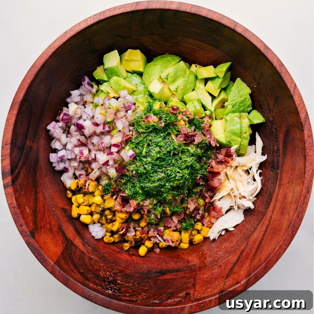 All the ingredients in this recipe added to a bowl ready to be tossed together with the dressing.