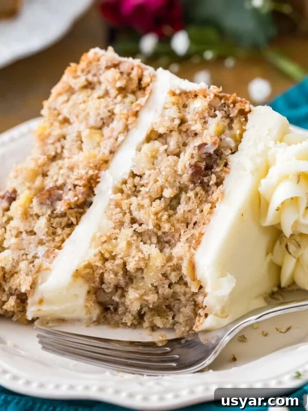 Classic Coconut Cake Recipe with Coconut Cream Frosting 9 Slice of cream cheese frosted hummingbird cake on a white plate