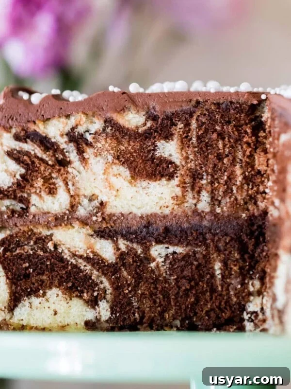 Classic Coconut Cake Recipe with Coconut Cream Frosting 11 Marble cake on cake platter with slice taken out