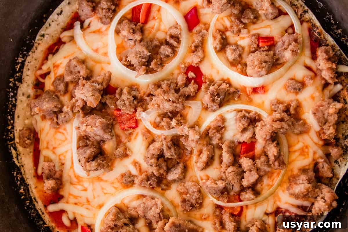 Sourdough Sausage Pizza Recipe with Crispy Golden Crust 2 A sausage sourdough pizza in a cast iron skillet.