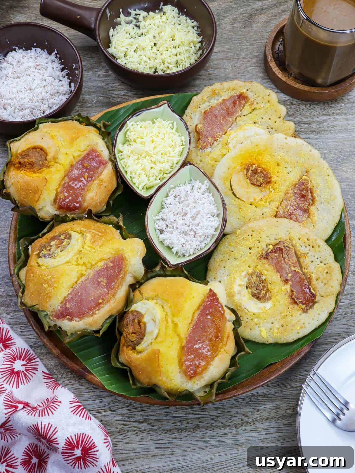 oven baked bibingka and bibingka pancakes on a banana lined platter with shredded cheese and grated coconut on the side.