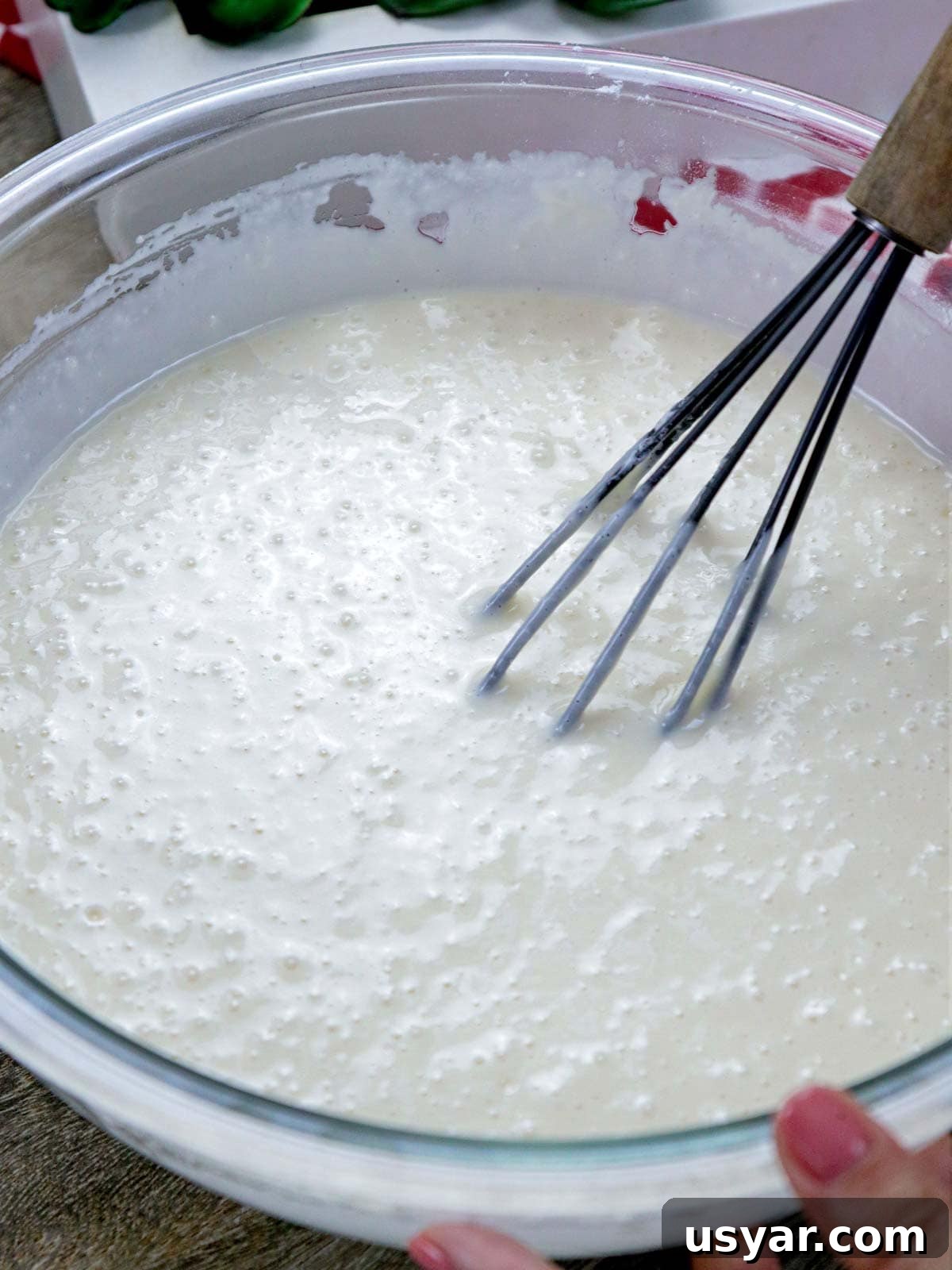 making bibingka pancakes in a bowl.