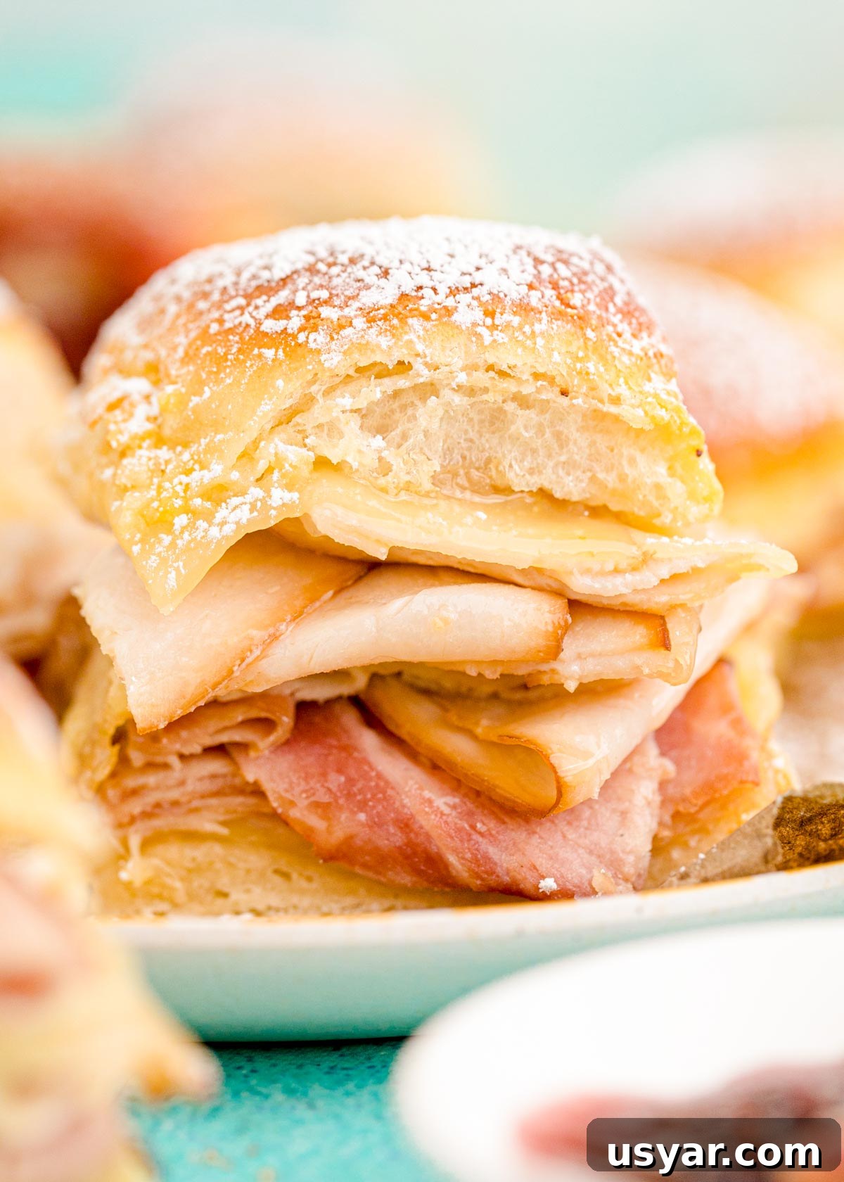 Close up photo of monte cristo sliders on a plate.