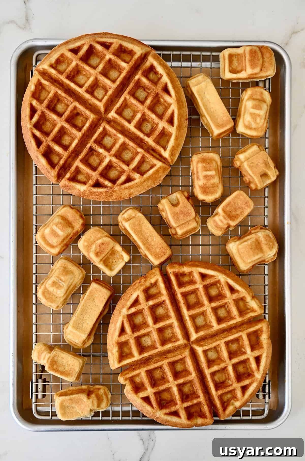 High-Protein Waffles: Fluffy, Filling Breakfast Recipe 6 Two Belgian-style protein waffles cooling on a wire rack along with car-shaped waffles.