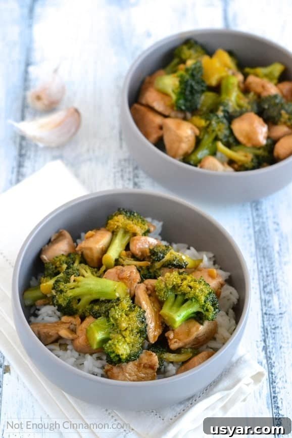 overhead shot of two bowls of Chicken and Broccoli Stir-Fry on rice