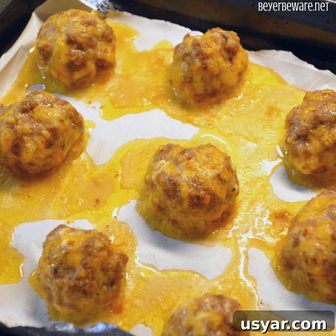 Baked low-carb sausage balls on a serving plate.