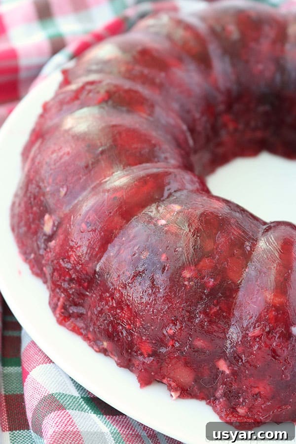 Old Fashioned Cranberry Salad with Pineapple and Pecans 2 Cranberry Salad Jello Mold on a white plate.