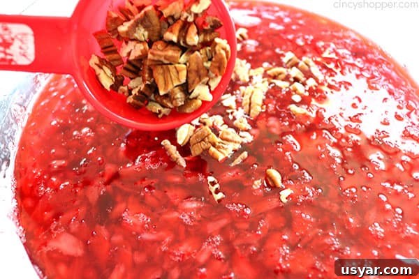 Old Fashioned Cranberry Salad with Pineapple and Pecans 13 Adding crushed pecan nuts to Cranberry Jello Salad.