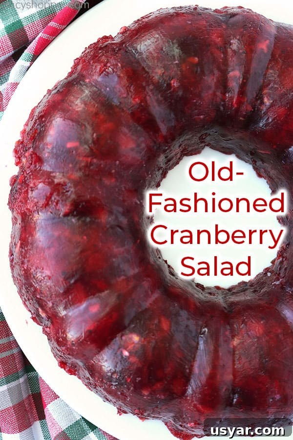Old Fashioned Cranberry Salad with Pineapple and Pecans 3 Cranberry Jello Mold on a white plate.