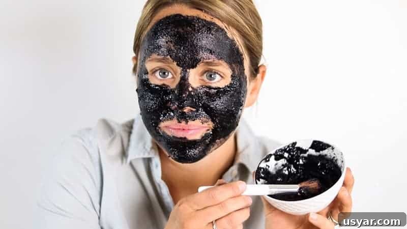 Using a makeup brush to apply peel-off face mask.