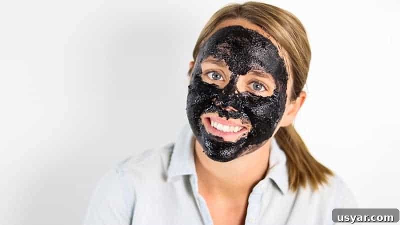 Homemade charcoal face mask on woman's face.