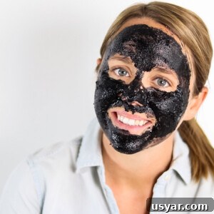 Charcoal face mask on woman's face