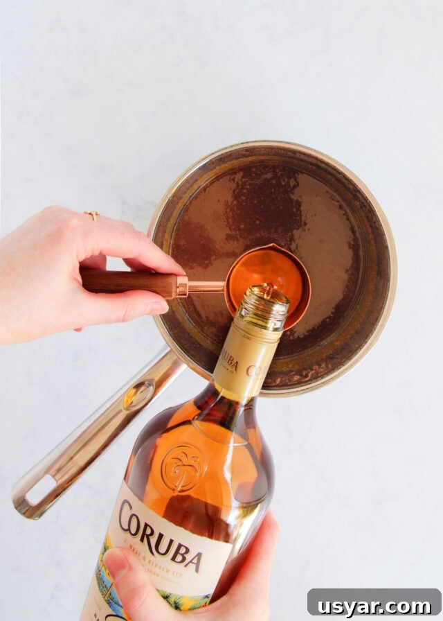 Rum Caramel Sauce Recipe 13 The rum being added to the caramel.