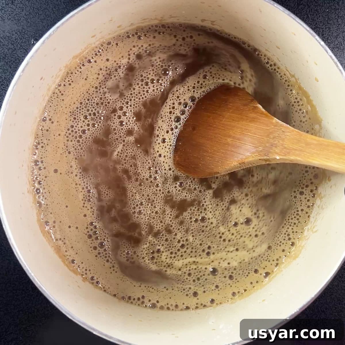 Coca Cola Glazed Ham Recipe 11 Stirring the cocacola ham glaze with a wooden spoon.