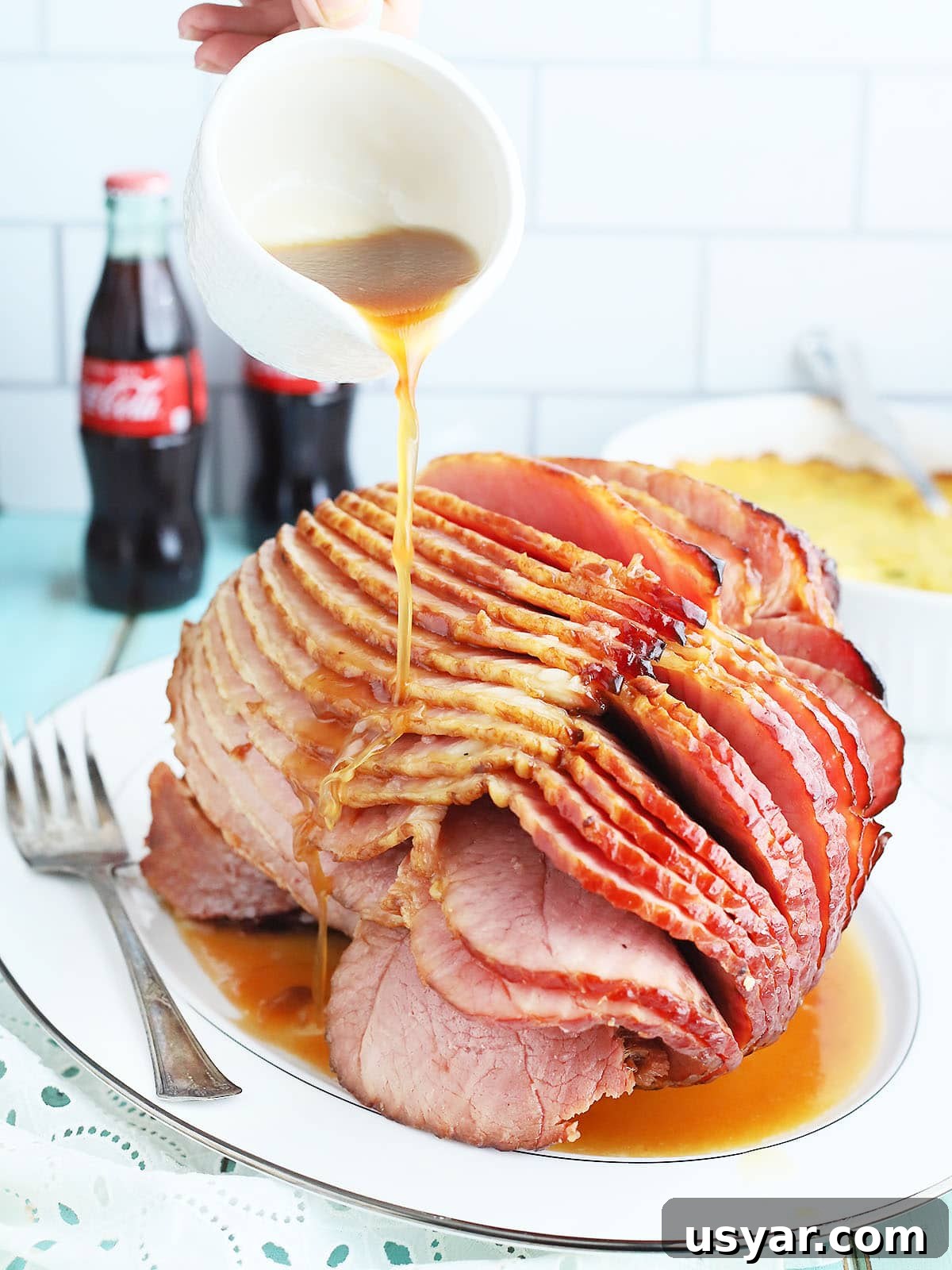 Coca Cola Glazed Ham Recipe 4 Pouring the glaze over the sliced baked ham.