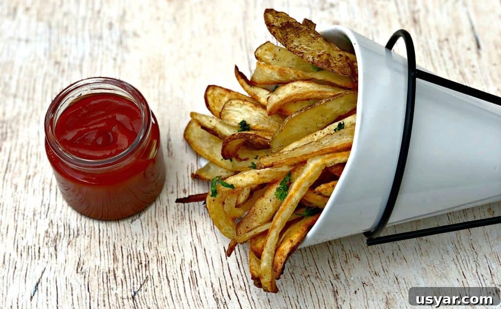 Crispy Homemade Air Fryer French Fries 8 air fryer fries in a white can with ketchup