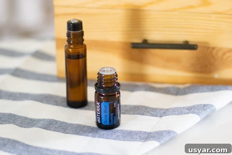 Deep Blue Essential Oil: Uses, Benefits and Application Tips 5 deep blue essential oil and roller bottle in front of wooden essential oil storage box