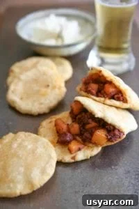 Crispy Mexican Chorizo and Potatoes Recipe 3 Potatoes with Mexican chorizo tucked inside tortillas with a glass of beer on the side.