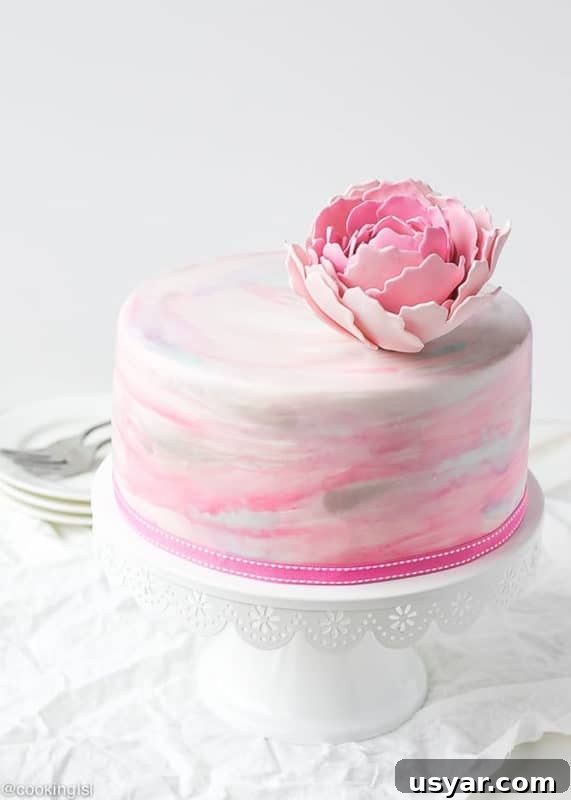 Custom Cakes for Weddings, Birthdays and Special Events 7 Pink, white and gray fondant cake topped with a pink fondant flower.