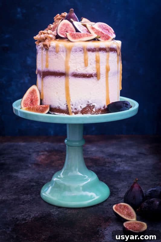 Custom Cakes for Weddings, Birthdays and Special Events 9 3 tiered Honey Walnut Fig Cake sitting on a blue cake display topped with figs, honey dripping down cake.