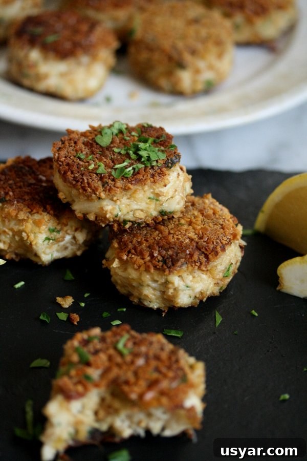 Pretzel-Crusted Gluten-Free Crab Cakes Recipe 8 gluten-free crab cakes with pretzel crust on a tray