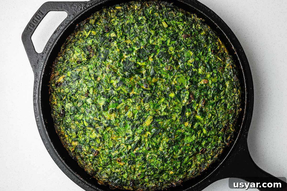 Kuku Sabzi Persian Herb Frittata Recipe 12 A vibrant green baked kuku sabzi in a cast-iron skillet.