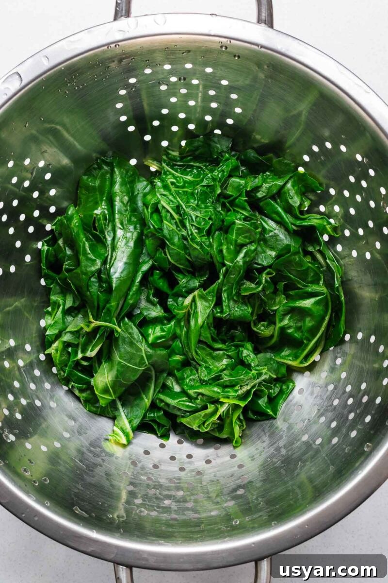 Kuku Sabzi Persian Herb Frittata Recipe 6 Blanched Swiss chard leaves in a colander viewed from above.