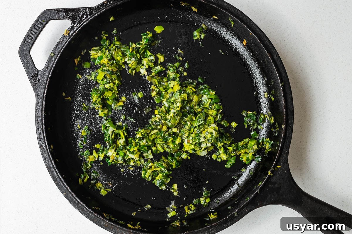 Kuku Sabzi Persian Herb Frittata Recipe 7 Finely chopped leeks cooked in a cast-iron skillet.