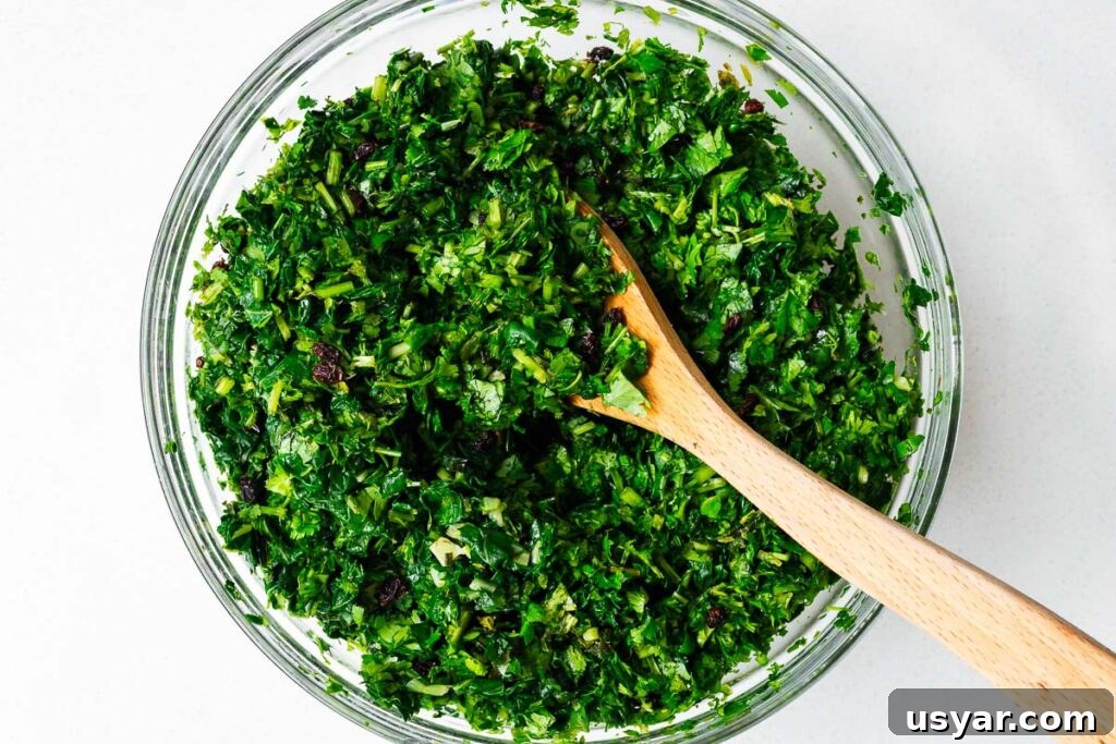 Kuku Sabzi Persian Herb Frittata Recipe 9 A large bowl of chopped herbs and greens.