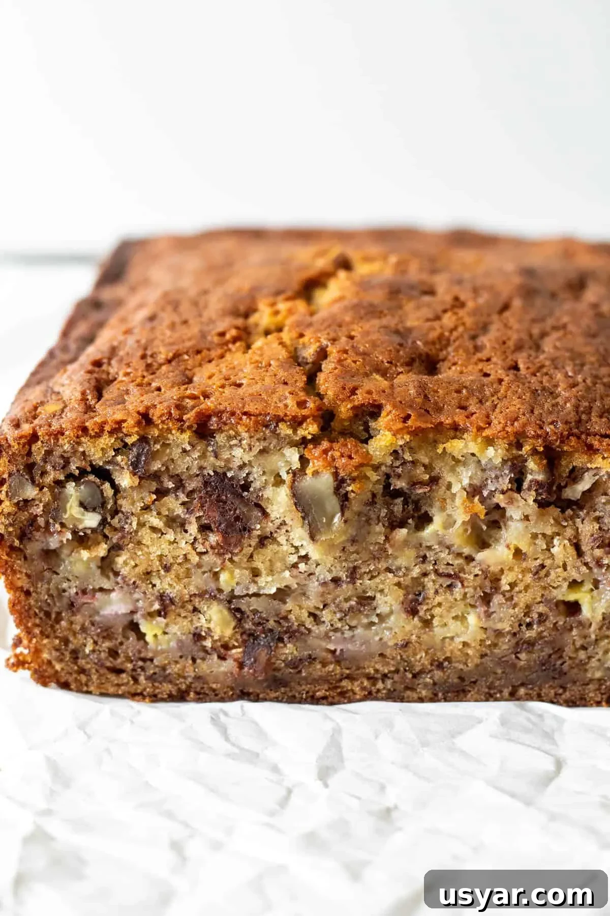 Moist Banana Bread Recipe with Ripe Bananas 7 Side view of cut loaf of banana bread showing close up of moist center.