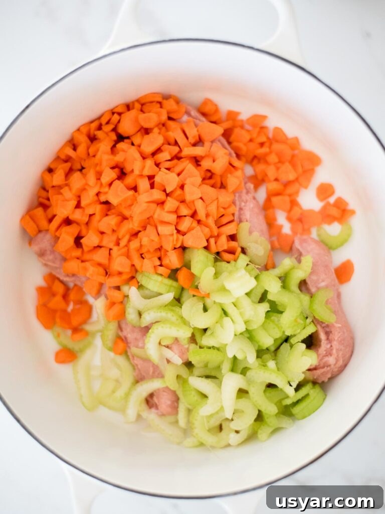 Authentic Italian Pasta e Fagioli Soup Recipe 5 carrots and celery added to italian sausage in the dutch oven