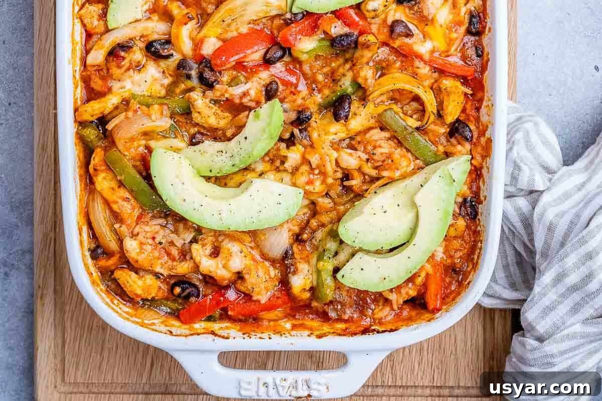 Cheesy Chicken Fajita Casserole Recipe 5 chicken fajita in a dish topped with sliced avocado.