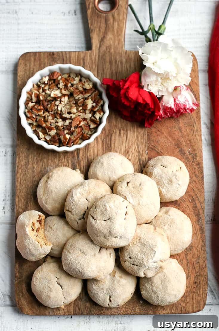 Paleo Mexican Wedding Cookies Recipe 6 Paleo Mexican Wedding Cookies cooling before being rolled in powdered sugar.
