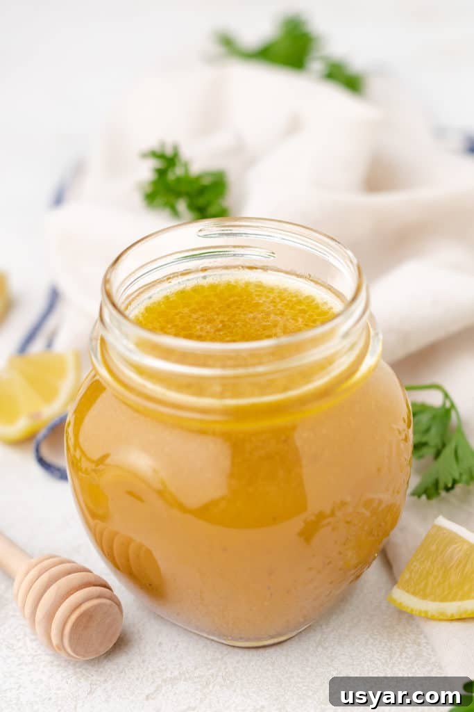 Honey Lemon Vinaigrette Salad Dressing Recipe 2 Side view of a jar of lemon dressing.