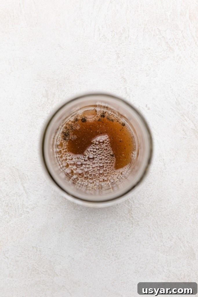 Honey Lemon Vinaigrette Salad Dressing Recipe 3 Top down view of honey and vinegar added to a jar.