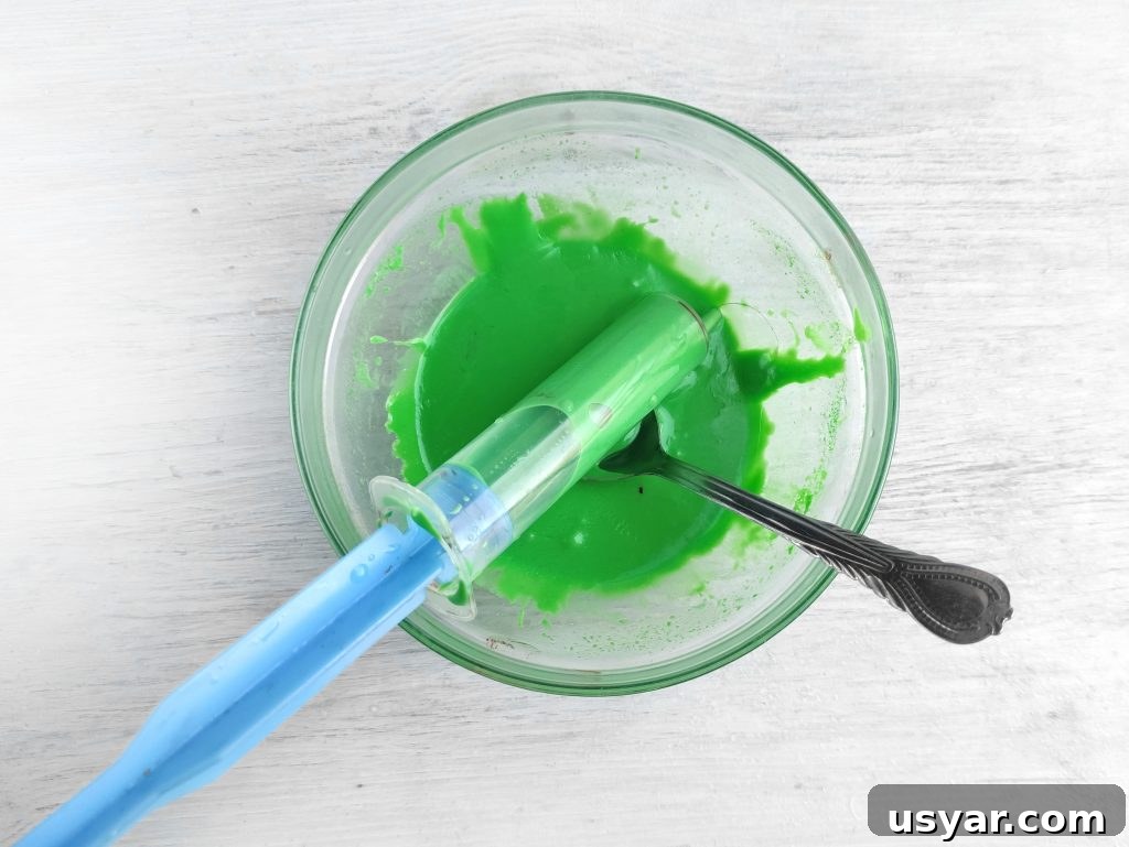 How to Make Frankenstein Chocolate Bars for Halloween 4 Piping green chocolate onto candy bars
